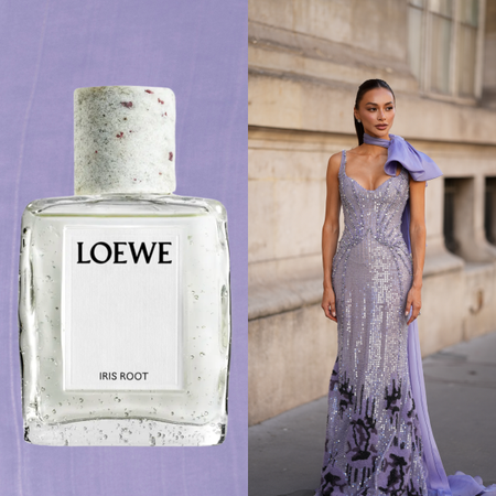 A woman wearing a purple gown with an oversized bow detail on her left shoulder. She is next two a bottle of perfume that feature an orris note. 