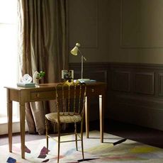 study room with rug on floor and wooden desk with chair