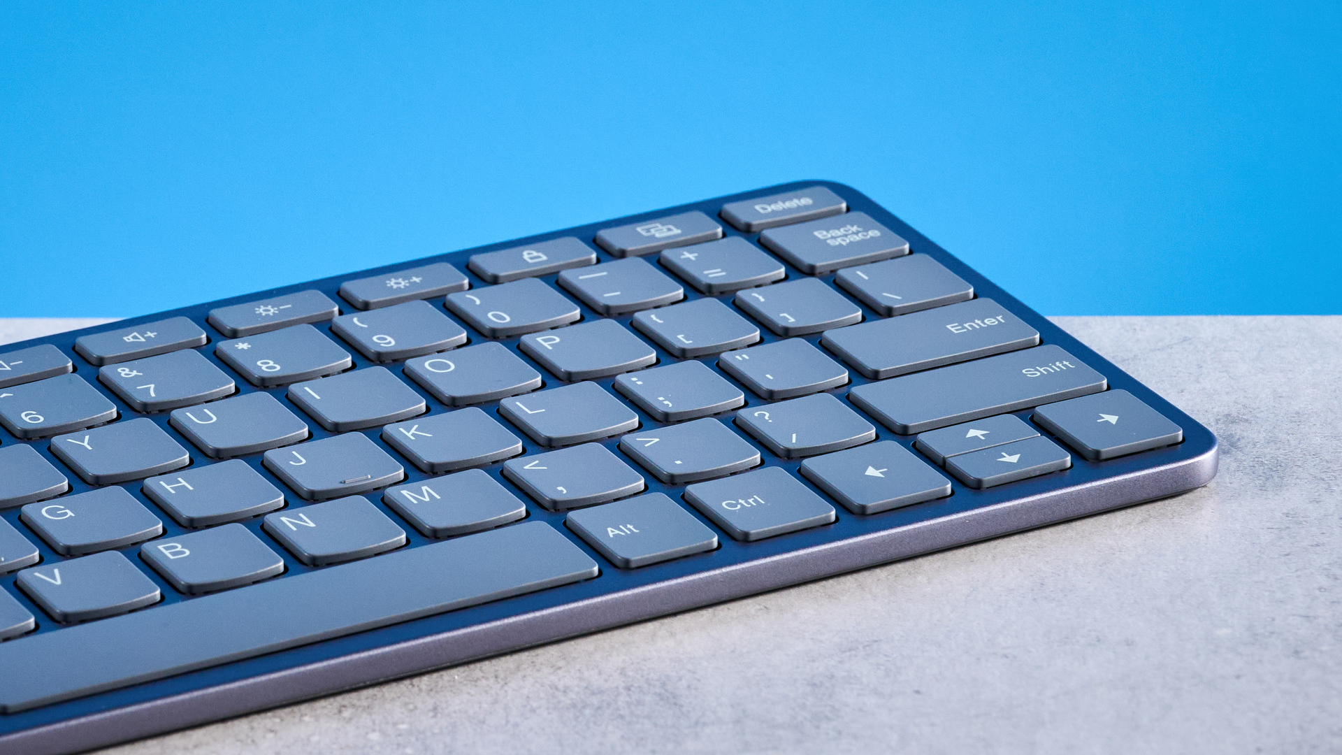 Lenovo Multi Device Keyboard photographed in front of a blue background.