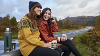 autumnal equinox 2022 feature image; two women in cozy fall gear outside near mountains and tress changing color