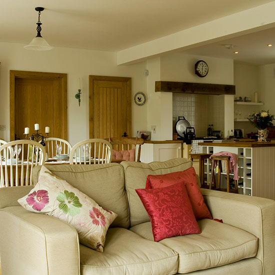 kitchen area with cream ceiling and sofa with cushions