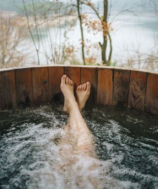 person relaxing in a wood-fired hot tub