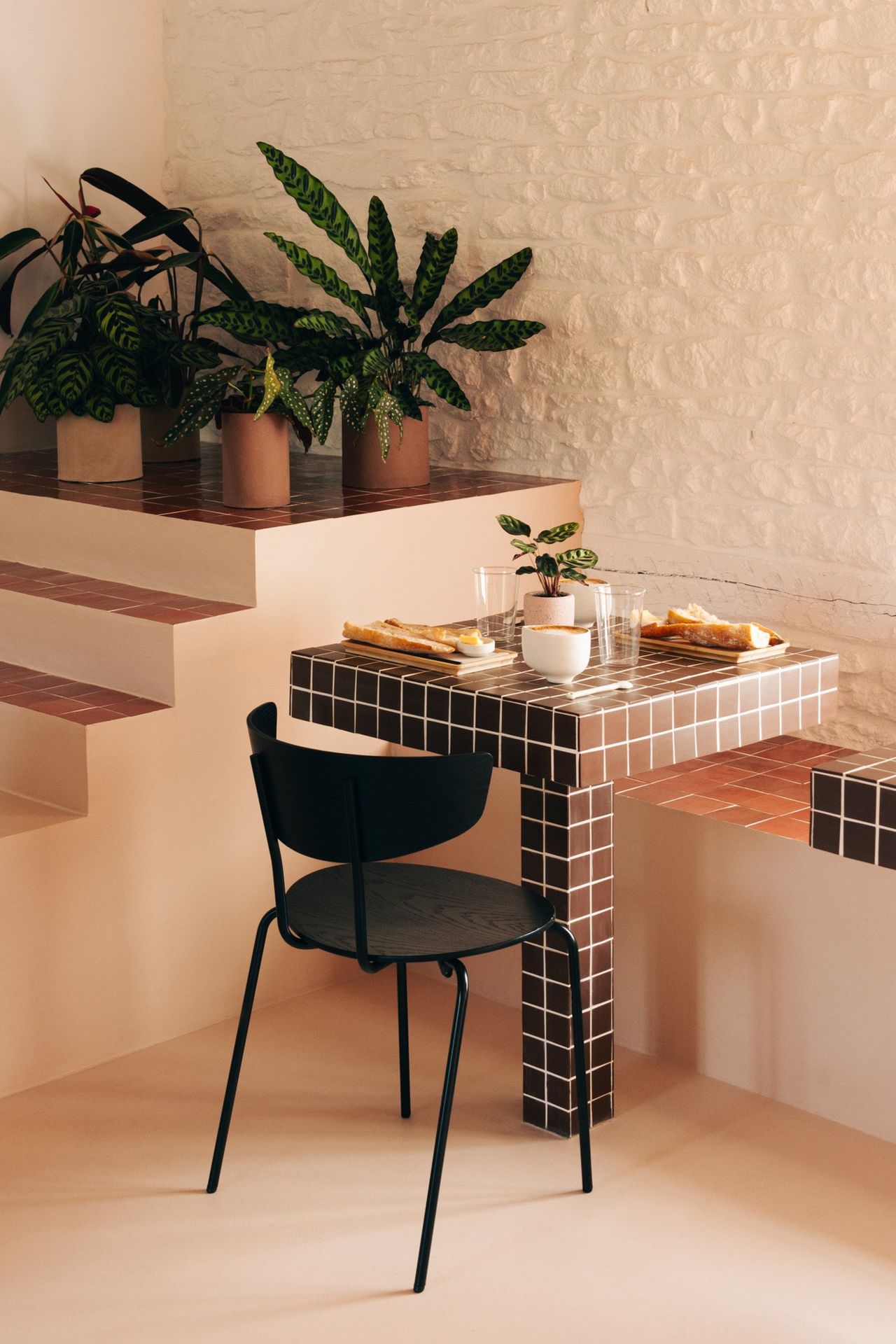 A whimsically decorated guesthouse pairs imaginative, color-blocky interiors with soft lines and palettes with a leafy, nature-immersed exterior.