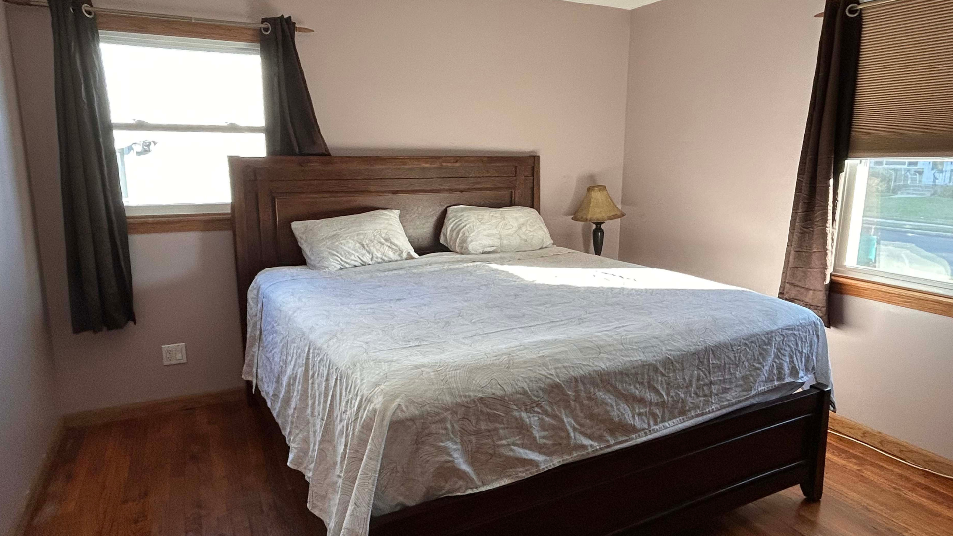 Brooklinen Luxe Sateen Core Sheet set spread on the bed in a brightly lit room