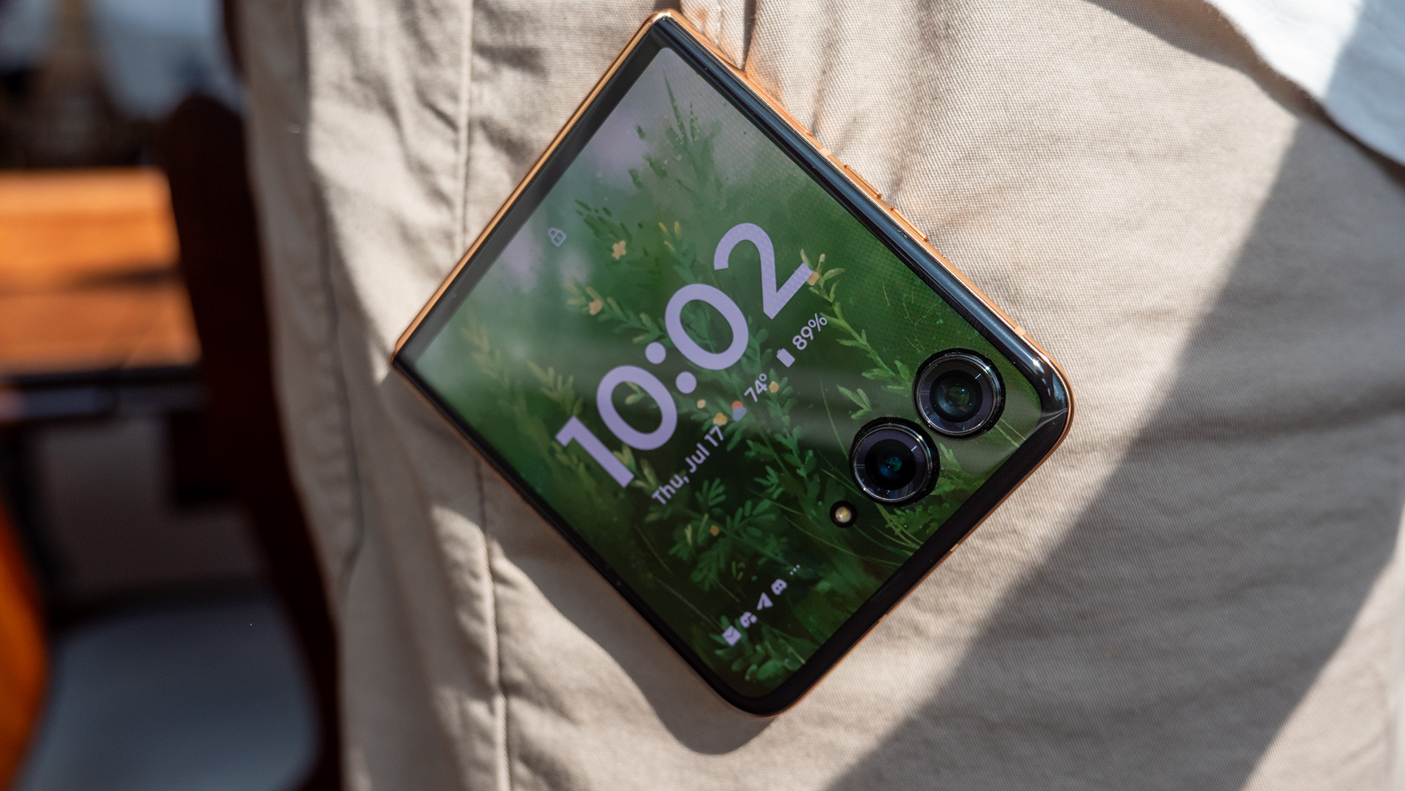 The Motorola Razr Plus 2025's cover screen hanging out of a pocket
