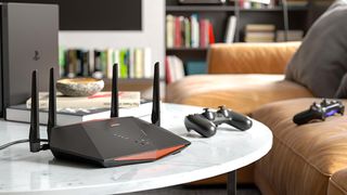 Netgear router shown in living room next to PlayStation controllers