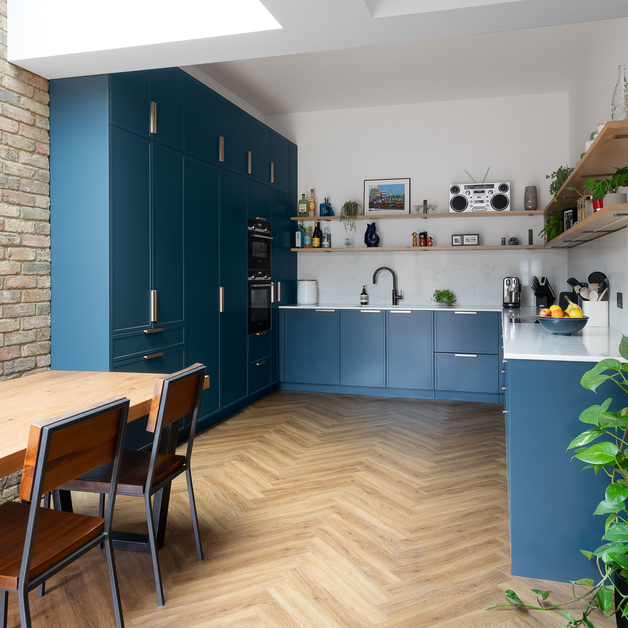 modern blue kitchen with herringbone wooden flooring