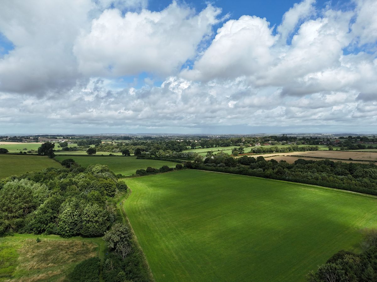 DJI Air 3 photo of a field on a sunny day with the 24mm wide camera