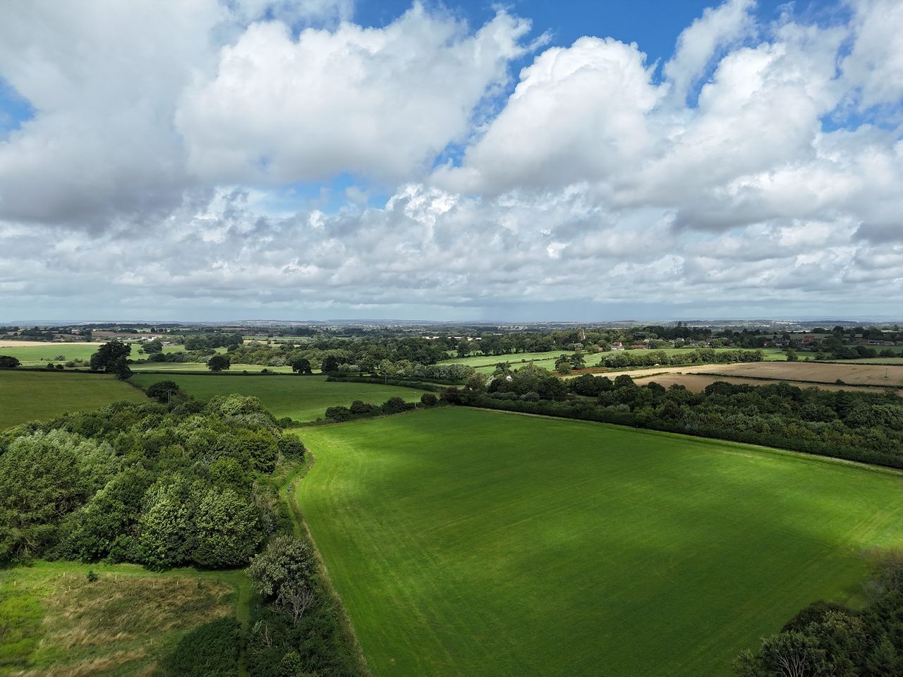 DJI Air 3 photo of a field on a sunny day with the 24mm wide camera