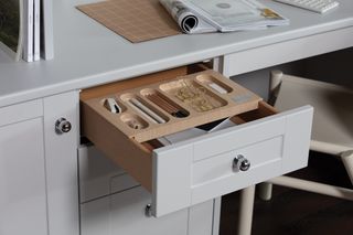 Organized office desk drawer with integrated drawer organizer.