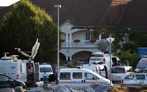 Police and the media arrive in car loads to Astana's hotel after the team announced Alexandre Vinokourov had tested positive to blood doping.