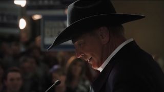 Kevin Costner in profile wearing a black cowboy hat