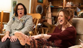 Barb and Star Go to Vista Del Mar Vanessa Bayer laughs while showing Phyllis Smith her socks