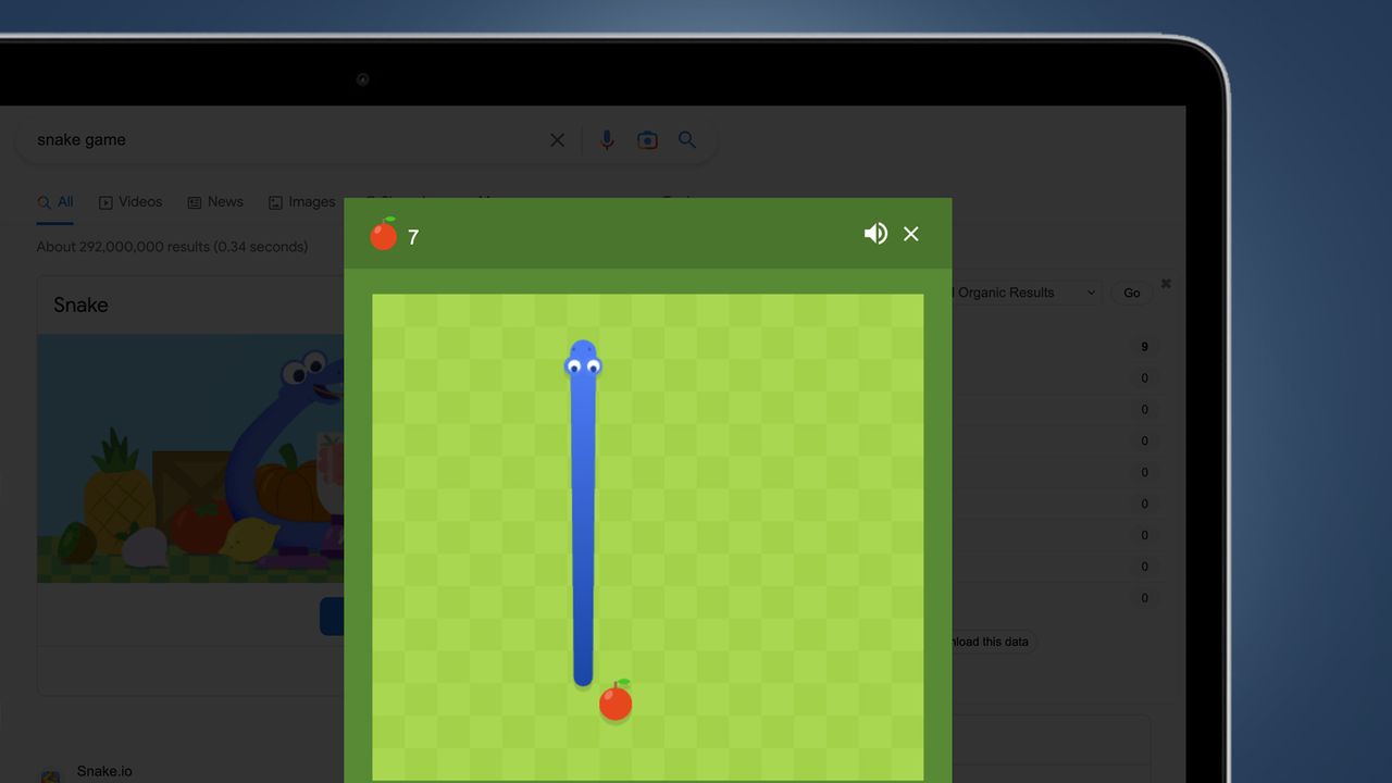 A laptop screen on a blue background showing a Google's Snake game easter egg