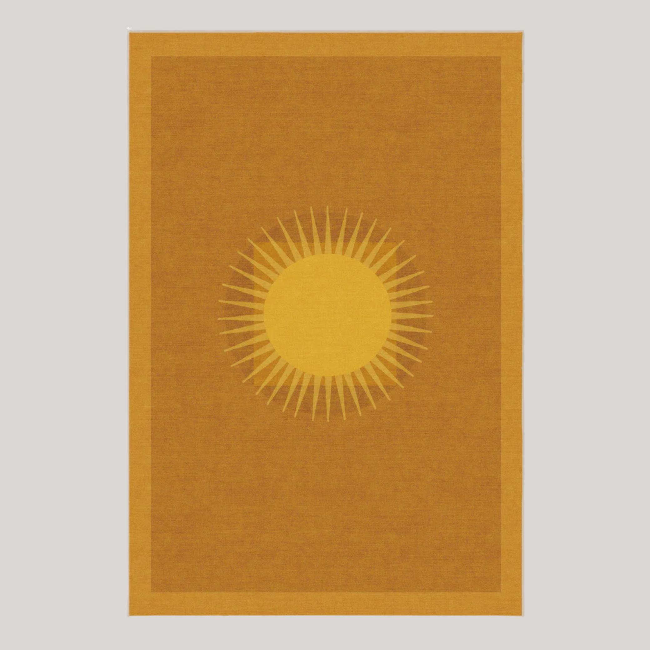 Ruggable Helios Gold Rug by Matthew Williamson, decorated with a central sun, placed against pale brown background.