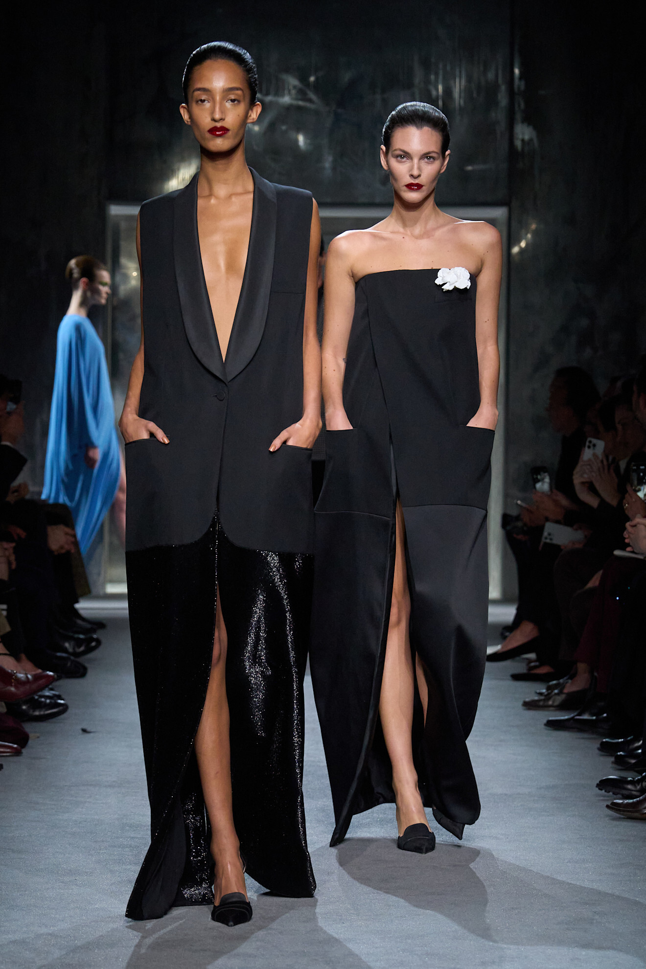 A model wears a tuxedo-inspired dress on the Tom Ford Fall 2025 runway.