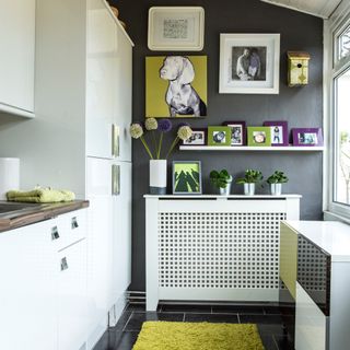 kitchen with white units, grey floor, open shelving and white radiator cover