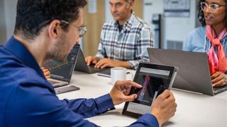 A group of people using Autodesk software whilst working in an office.