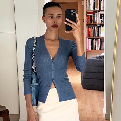 TyLynn Nguyen wearing a blue cardigan and white miniskirt