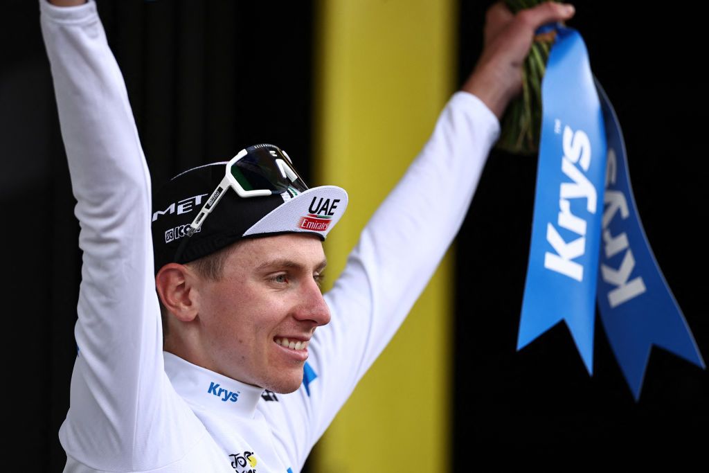 UAE Team Emirates' Slovenian rider Tadej Pogacar celebrates on the podium with the best young rider's white jersey after the 11th stage of the 110th edition of the Tour de France cycling race, 180 km between Clermont-Ferrand and Moulins, in central France, on July 12, 2023. (Photo by Anne-Christine POUJOULAT / AFP)