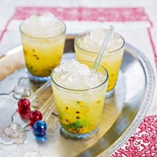 Passionfruit cocktails on tray with glass stirrers