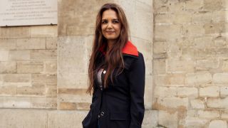 Katie Holmes wears a navy blue and red jacket, dark blue denim jeans, black shoes and a white bag outside Patou during the Haute Couture Fall/Winter 2024/2025 as part of Paris Fashion Week on June 27, 2024 in Paris, France.