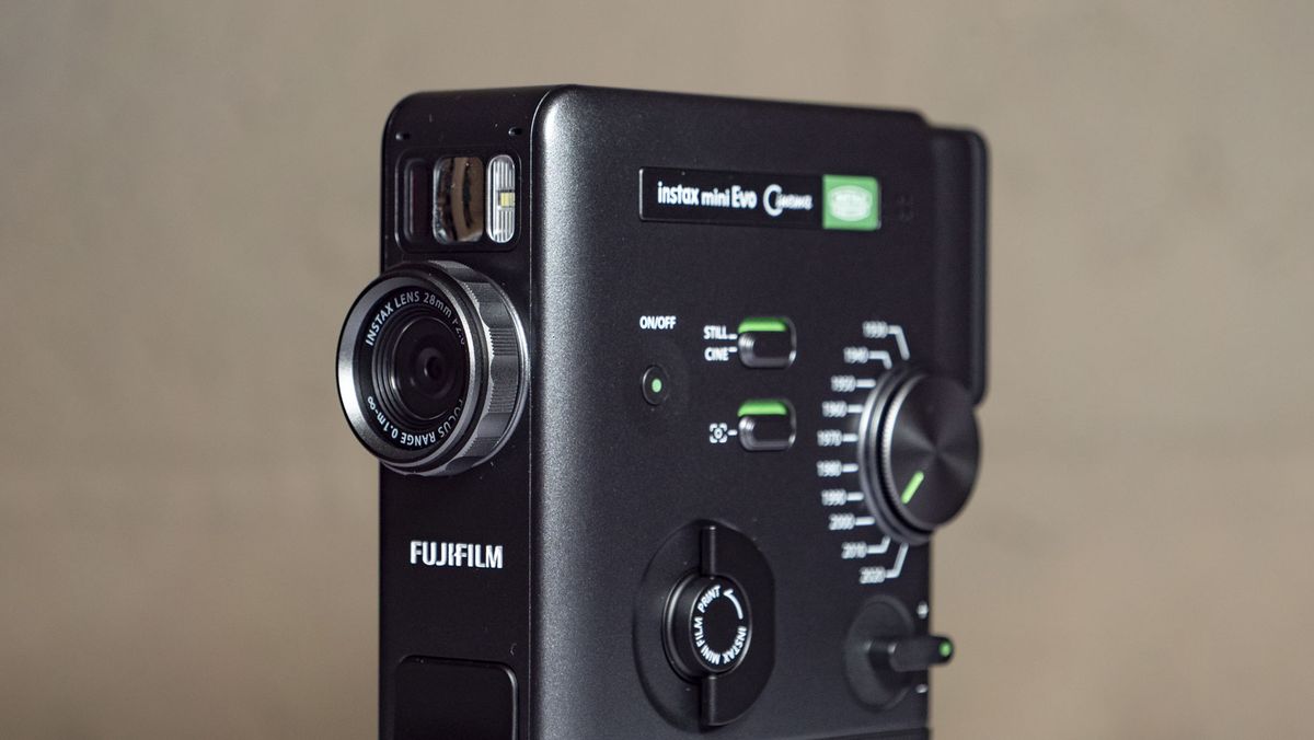 Fujifilm Instax Mini Evo Cinema on a white wooden surface
