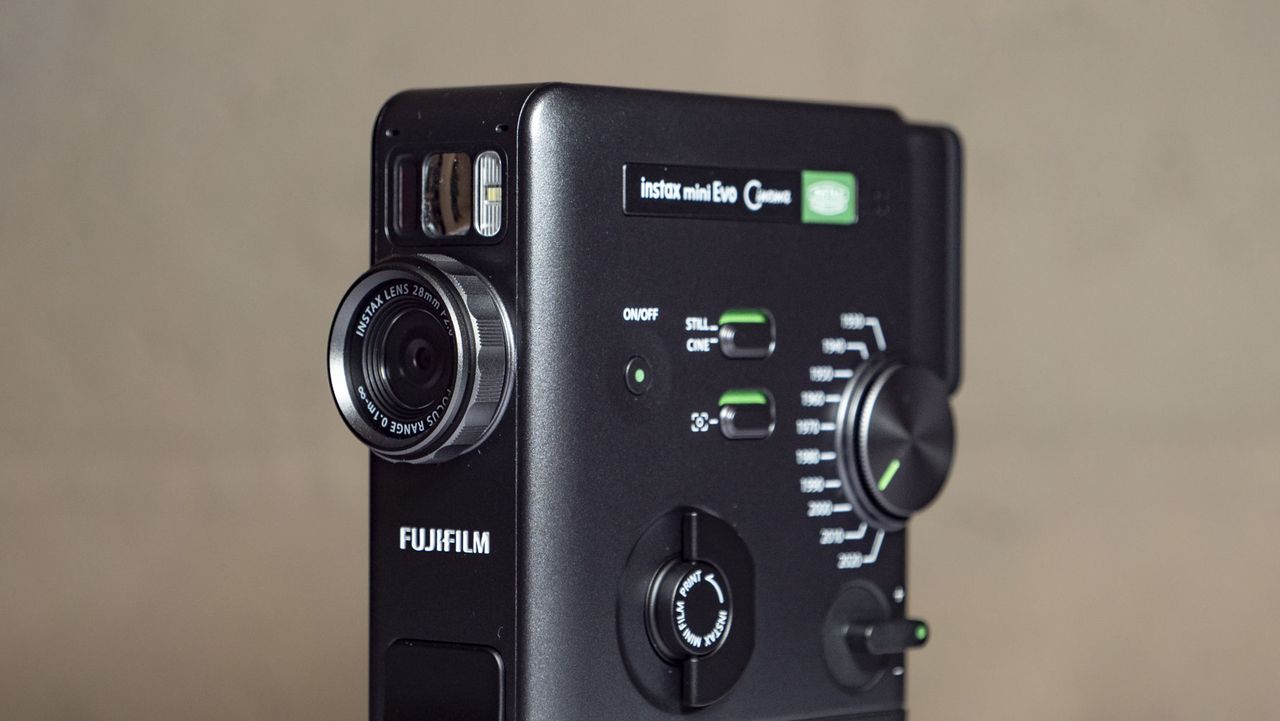Fujifilm Instax Mini Evo Cinema on a white wooden surface