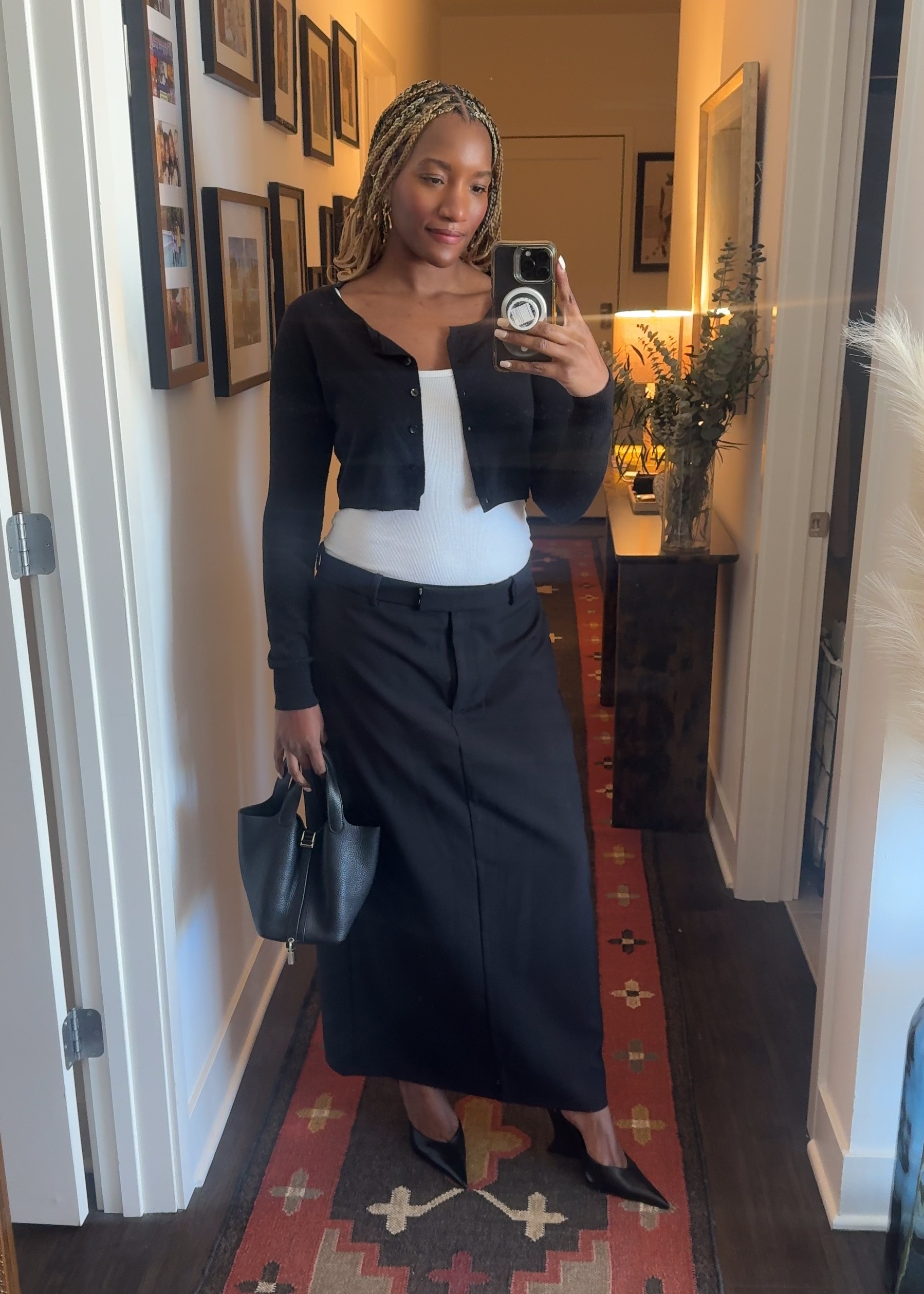 Danielle Prescod wearing a cropper cardigan, a slip skirt, and heels