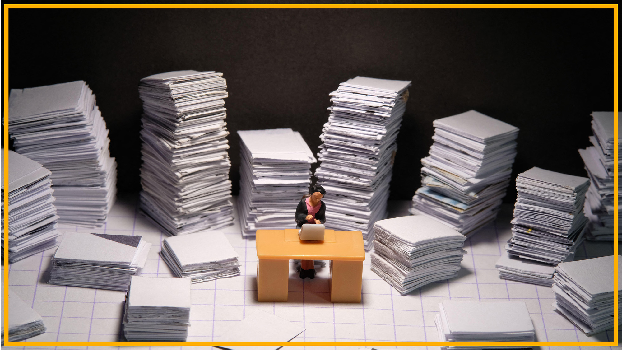 A miniature shows a woman sitting behind a desk with piles of paper around her