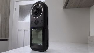 Kandao QooCam 8K 360 camera on a white walled room