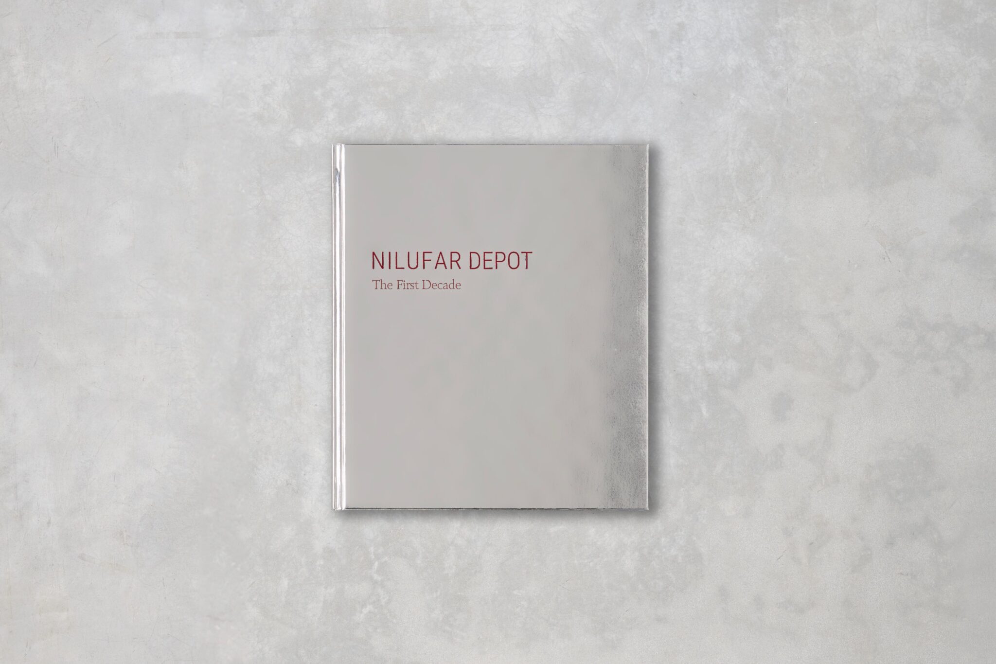 A book with silver cover shown on a gray background