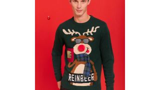 best Christmas jumpers illustrated by a jumper with a reindeer holding a beer on it