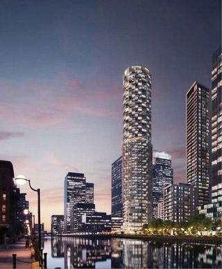 Night view of tall, thin, modern residential building in Canary Wharf