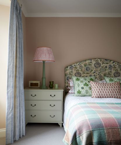 bedroom with pink walls and patterned headboard in Edinburgh Georgian townhouse designed by Jessica Buckley