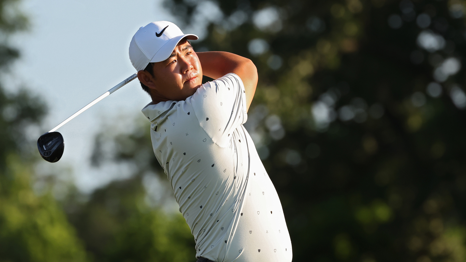 Tom Kim hits a fairway wood