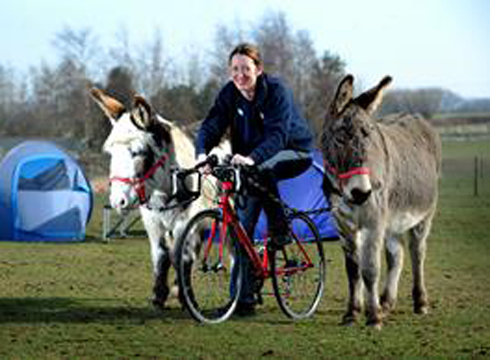 The Donkey Sanctuary Assisted Therapy Centre, Swan Lane, Off Blackhill Lane, Eccup, are palnning to host a special Tour de France campsite for 60 families to enjoy the road race while pitching tents in a field adjacent to 20 donkeys. All money raised by the campsite will go towards the charity and its donkey assisted riding therapy centre. Pictured On her bike Kirsty Chrsitmas, (Riding Instructor &amp;amp; Fund Raiser) with Donkey's Doodles and Eli. Date:13th March 2014, Picture James Hardisty, (JH1002/93e)