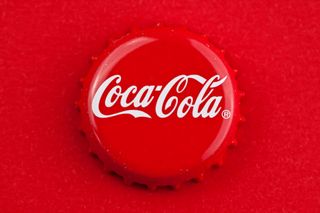 coca cola bottle cap on red background