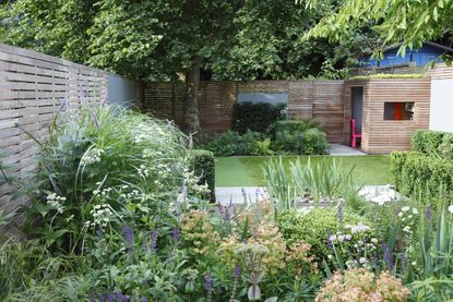 family garden ideas: playhouse at end of garden