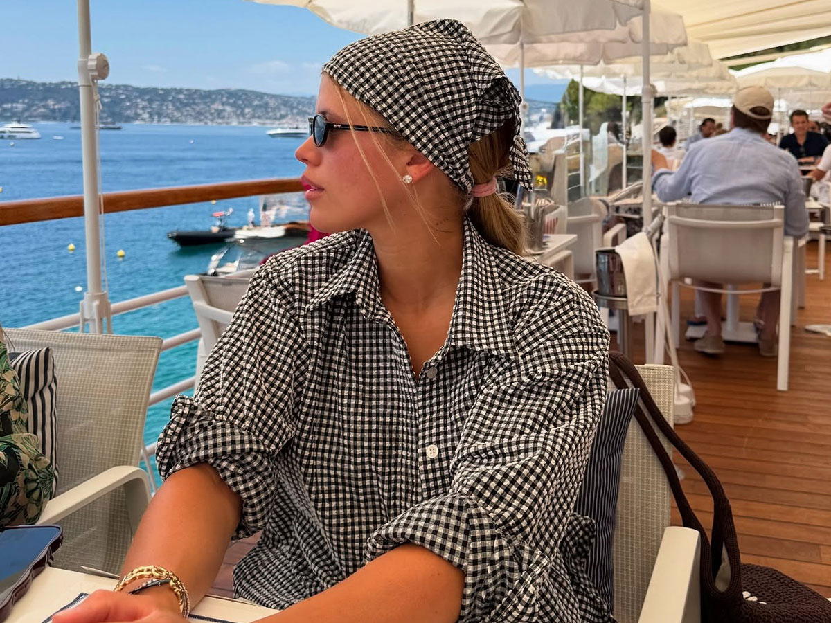 @sofiagrainge instagram photo at beachside restaurant in gingham shirt dress and gingham bandana