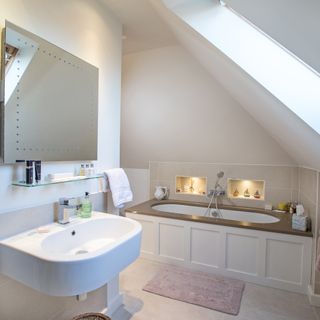 attic white bathroom with washbasin and bathtub