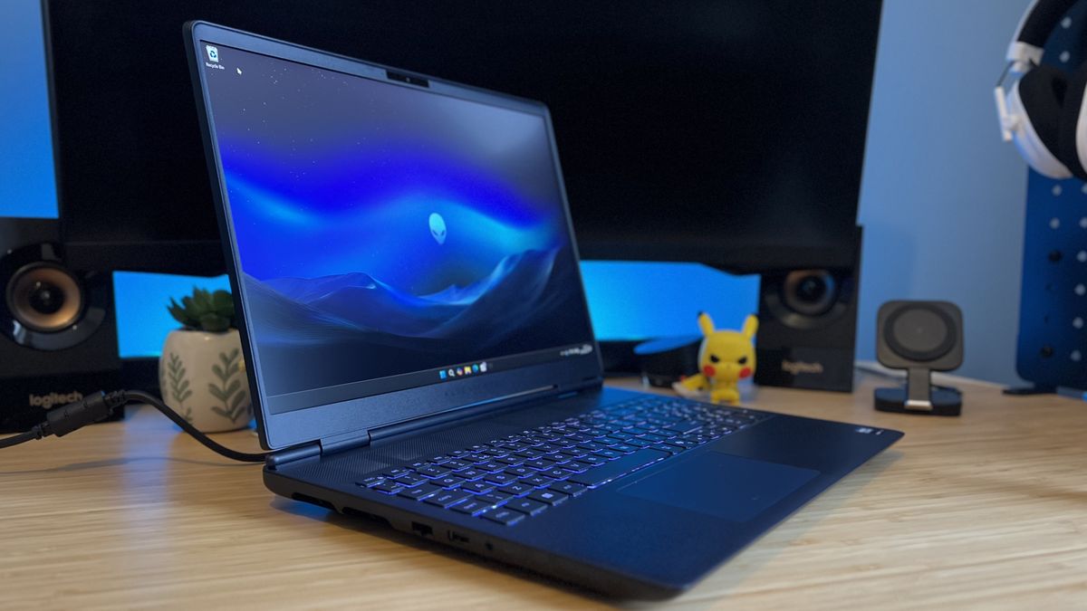 Side view of Alienware 16X Aurora gaming laptop on a wooden desk