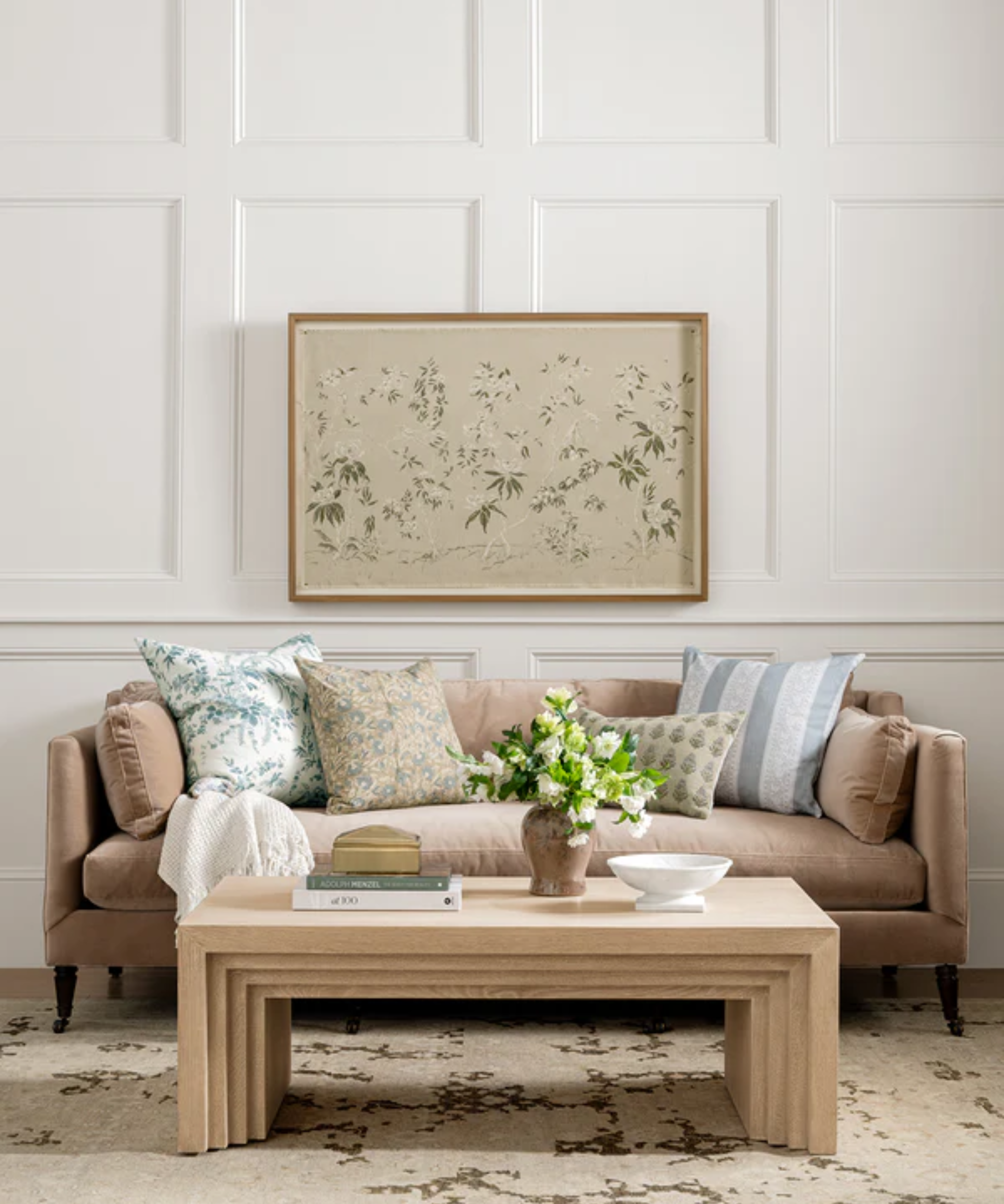 a living room with a couch with many pillows on it