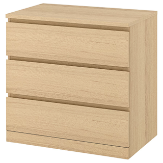 A three drawer oak effect dresser
