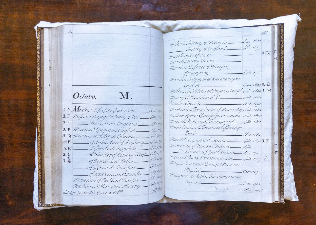 Charlie Courtenay, 19th Earl of Devon with his ancestor's book at Powderham Castle.