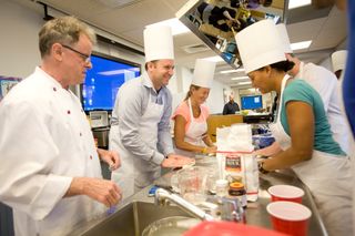 Mock Mars mission participants practice cooking.