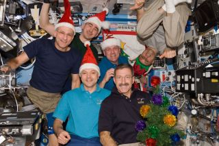 Expedition 30 crewmembers celebrate Christmas on the International Space Station in 2011. The Expedition 54 crew will do the same on Dec. 25, 2017.