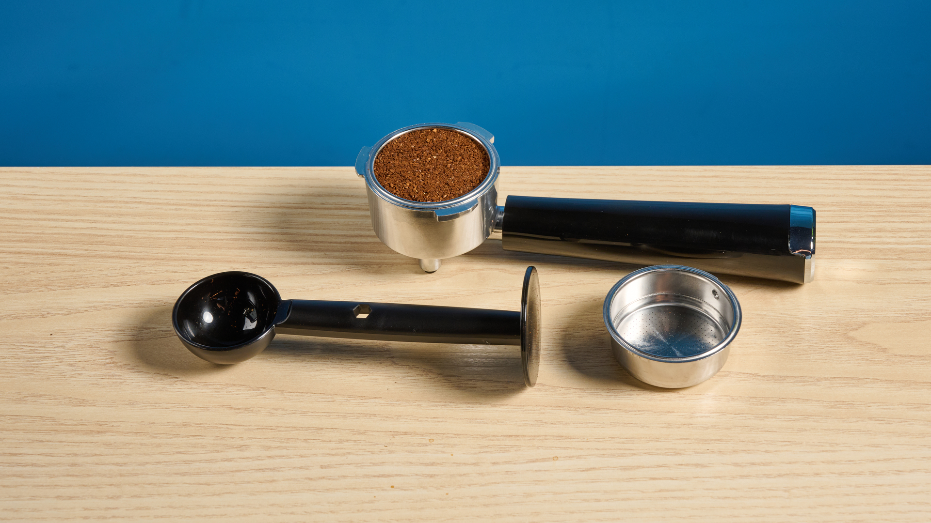 the casabrews cm5418 espresso machine in silver showing its steam wand and water tank and accessories