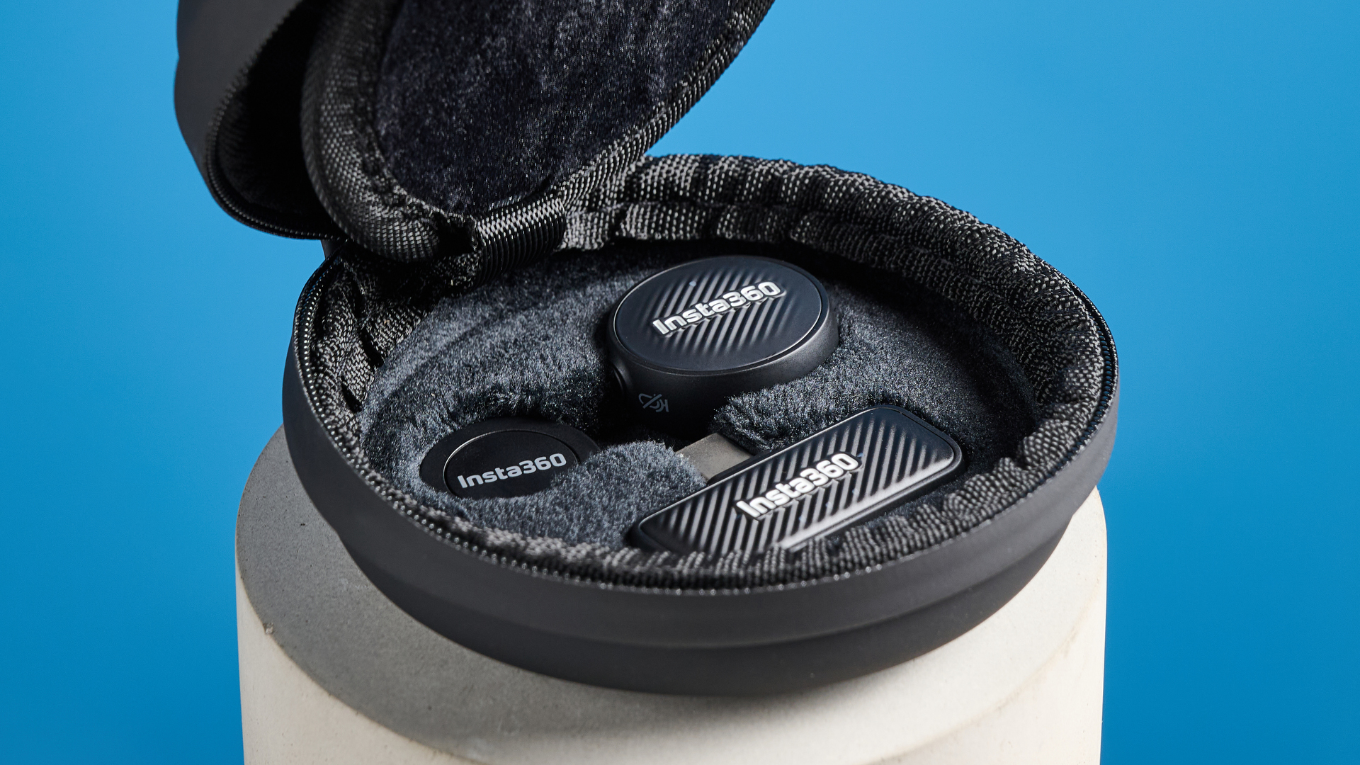 Insta360 Mic Air photographed on a blue background