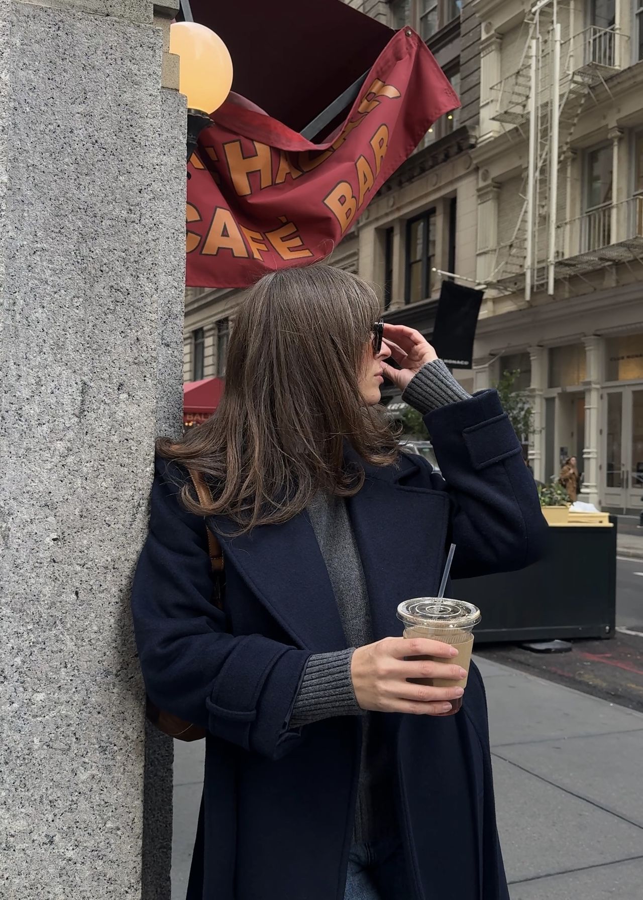 Kathryn Zahorak looking away and wearing black coat, navy sweater